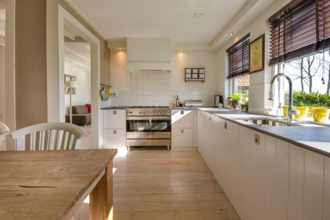 Clean, bright kitchen with a wooden table